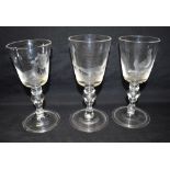 THREE MATCHING ALE GLASSES the bowls each engraved with cockfighting scenes, on knopped stem with