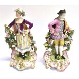 A PAIR OF 19TH CENTURY CONTINENTAL FIGURES of a gentleman and his female companion, polychrome and