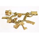 A 9CT GOLD CHARM BRACELET together with nine assorted 9ct gold charms and padlock fastener, the