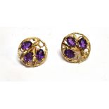 A PAIR OF THREE STONE AMETHYST SET 9CT GOLD EARRINGS the round stud earrings each set with three