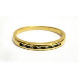 AN 18CT YELLOW GOLD BAND RING Channel set to front with six small diamonds alternating with small