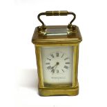 A MINATURE BRASS CASED CARRIAGE CLOCK the enamel dial inscribed 'WALTERS & GEORGE 270 REGENT