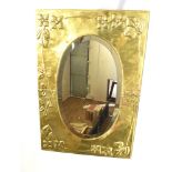 A BRASS FRAMED ARTS & CRAFTS STYLE WALL MIRROR the oval bevelled mirror 34cm x 58cm, the brass frame