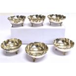 A SET OF SIX ASIAN SILVER LARGE CONDIMENT BOWLS The three footed round cauldron form bowls with