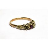 A RED AND WHITE THREE STONE 9CT GOLD DRESS RING small red central synthetic ruby, one white stone