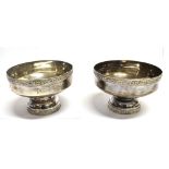 A PAIR OF INDIAN SILVER ROUND PEDESTAL BOWLS The pedestal bases and rims with applied flowerhead
