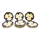 ELEVEN MATCHING VICTORIAN DESSERT PLATES with painted floral and gilt decoration on a Royal blue