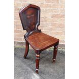 A VICTORIAN MAHOGANY HALL CHAIR on tapering octagonal front supports