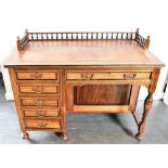AN EDWARDIAN SINGLE PEDESTAL DESK the top with three quarter gallery and leather inset top, frieze