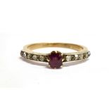 AN EARLY 20TH CENTURY RUBY AND DIAMOND SET RING The single small cushion cut ruby 4.5mm x 3.8mm, a
