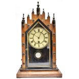 AN AMERICAN MANTLE CLOCK the 6' dial with Roman numerals, 29cm x 49cm overall