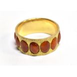 A FIRE OPAL full set 14ct yellow gold band ring with textured finish, gross weight 4.4 grams,