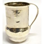 A LIBERTY & CO ARTS AND CRAFTS SILVER MUG The thistle shaped mug with planished decoration, name