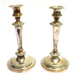 TWO SHEFFIELD PLATE CANDLESTICKS Of same pattern and design, one slightly larger than the other,