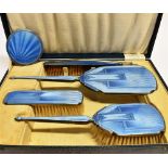 AN ART DECO BOXED SILVER AND BLUE PANELLED FOUR PIECE BRUSH SET Comprising mirror, hair brush,
