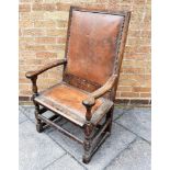 AN OAK ARMCHAIR WITH LEATHER UPHOLSTERED SEAT AND BACK on turned supports with stretcher base