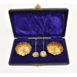 A VICTORIAN CASED PAIR OF MINIATURE SALTS AND SPOONS of crinkled fluted form, gilt interior with