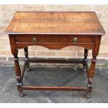 AN OAK SIDE TABLE with frieze drawer and shaped apron, turned supports with stretcher, 76cm wide