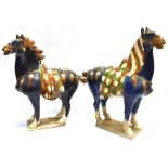 A LARGE PAIR OF CHINESE TANG STYLE FIGURES OF HORSES decorated in sancai glaze, 48cm high