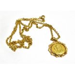 AN 18CT YELLOW MOTHER MARY ROUND PENDANT and 9ct gold chain, the pendant with decorated pierced