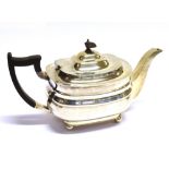 A SILVER TEAPOT of plain cushion form with square spout, on four ball feet with redwood handle and