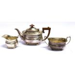 A SILVER THREE-PIECE TEASET the cushion form tea set with fluted corners on four bun feet, the