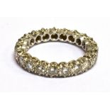 A DIAMOND AND PLATINUM FULL ETERNITY RING A total of twenty-one round brilliant cut diamonds, a