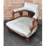 AN EDWARDIAN CARVED WALNUT FRAMED UPHOLSTERED TUB ARMCHAIR on turned supports