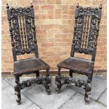 A PAIR OF OAK CAROLEAN STYLE SIDE CHAIRS with carved decoration
