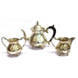 AN ASIAN SILVER THREE PIECE TEA SET Of plain pear shaped form on four scroll feet, waved applied