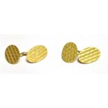 A PAIR OF 18CT GOLD OVAL CHAIN LINKED CUFFLINKS with engine turned pattern, hallmarks for 1919,