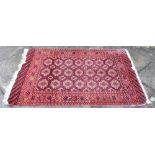 A RED GROUND BOKHARA RUG 94cm x 137cm