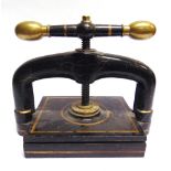 A CAST IRON & BRASS PORTABLE BOOK PRESS painted black, the pressing plate area 25cm x 30.5cm.
