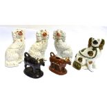 FOUR VARIOUS STAFFORDSHIRE SPANIEL FIGURES approx 26cm high, and two cow creamers
