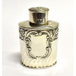 A SILVER TEA CANNISTER WITH COVER of oval form, spiral fluted decoration, c-scroll and floral