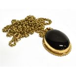 A 9 CARAT GOLD BLACK ONYX SET OVAL PENDANT AND CHAIN pendant with barley twist border, 3cm x 2cm, to