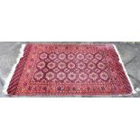 A RED GROUND BOKHARA RUG 94cm x 137cm