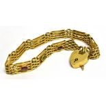 AN EDWARDIAN 15 CARAT GOLD STONE SET GATE BRACELET WITH PADLOCK FASTENER set with alternating oval