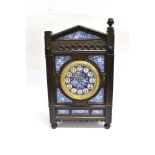 A LATE VICTORIAN AESTHETIC DESIGN MANTLE CLOCK the ebonsied case inset with floral painted porcelain
