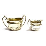 A SCOTTISH SILVER SUGAR BOWL AND MILK JUG of half fluted oval form with C scroll handle, hallmarks