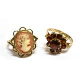 TWO 9 CARAT GOLD DRESS RINGS comprising a small oval cameo set, ring size K and a garnet flower head