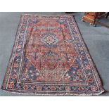 A RED GROUND RUG with central medallion and foliate motifs within border, 125cm x 200cm; and a small