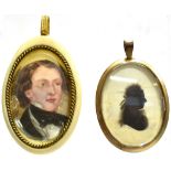 A SILHOUETTE LOCKET PENDANT the oval pendant comprising black silhouette of a lady, signed below the