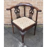 A MAHOGANY CORNER ARMCHAIR with pierced vase shaped splats, carved cabriole front support