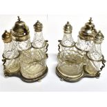 A PAIR OF VICTORIAN SILVER CONDIMENT STANDS each containing four cut glass condiment items