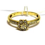 A DIAMOND FLOWER HEAD CLUSTER 18 CARAT GOLD RING the flower head cluster comprising seven round