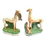 A PAIR OF STAFFORDSHIRE FIGURES OF HUNTING DOGS 26cm high