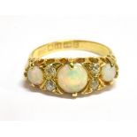 A VICTORIAN OPAL THREE STONE AND DIAMOND SET 18 CARAT GOLD RING boat shaped claw set head, carved