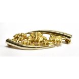 A 14 CARAT YELLOW GOLD SAFARI BROOCH the curved tusk design set with hippo, leopard, elephant,
