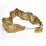 A 9 CARAT GOLD GATE BRACELET with padlock fastener and safety chain, the 6 bar gate bracelet,